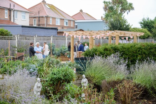 Photo of staff and residents enjoying the sensory garden at Copperfields.